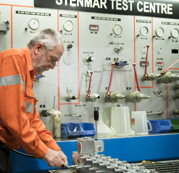 Technician setting up to test hydraulic system