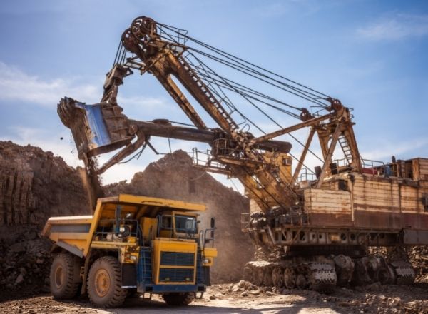 Mining excavator loads large dump truck